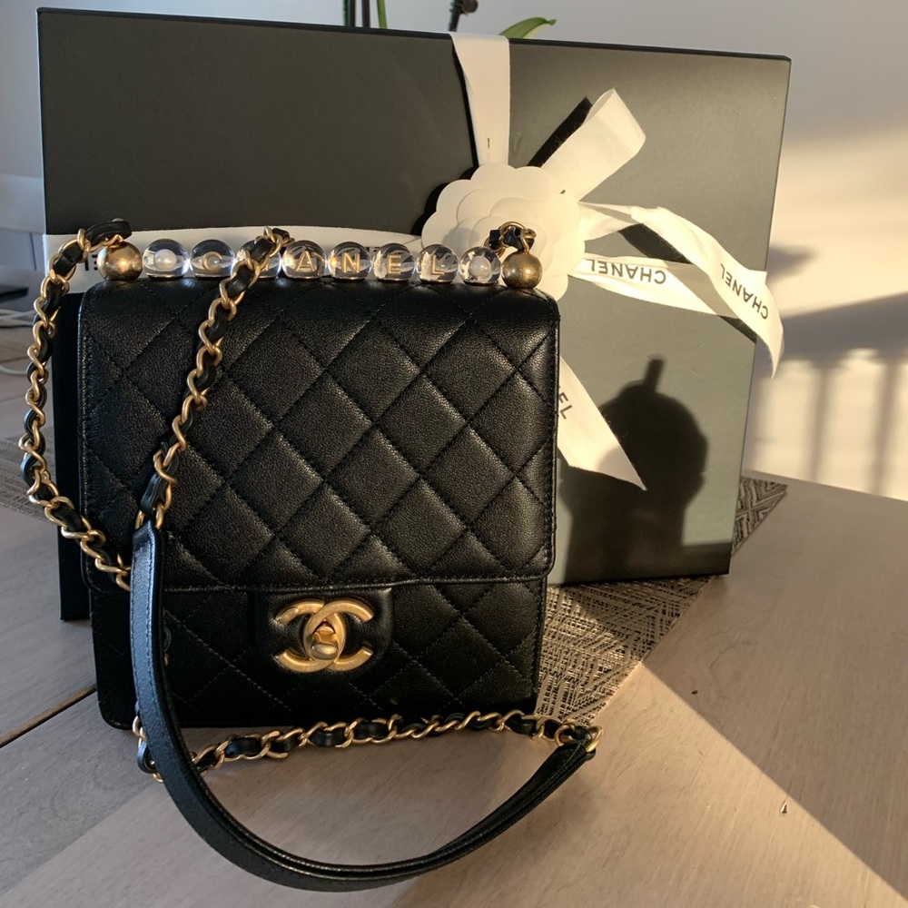 Chanel Pearl flat square bag.